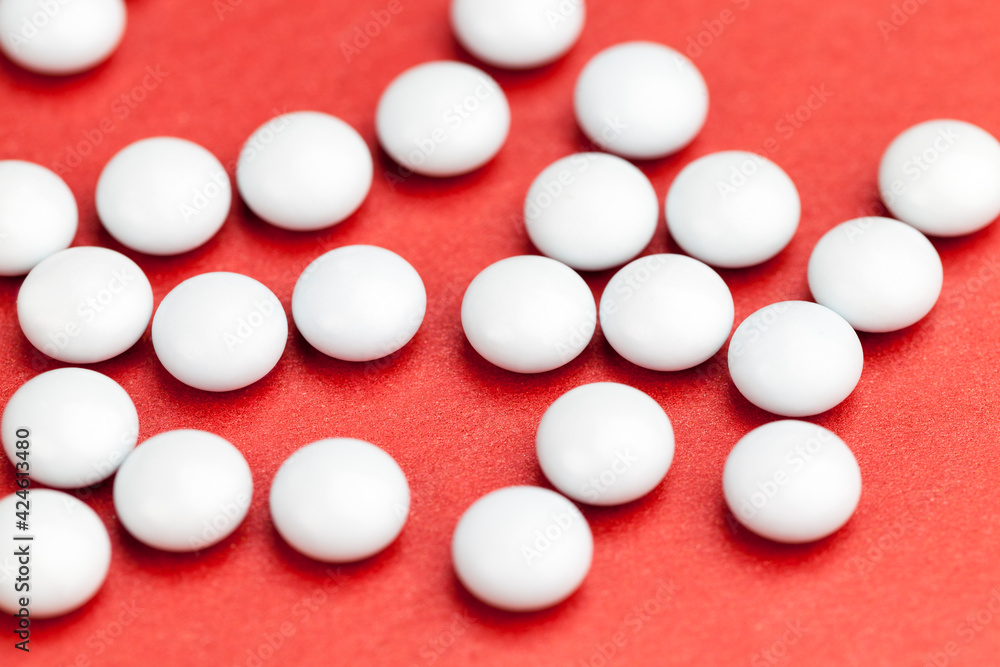 medicines for the treatment of diseases scattered on a red background