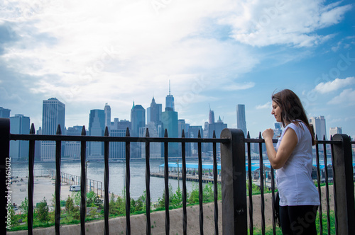 Female tourist enjoy panoramic view with Manhattan skyscrapers in New York, USA