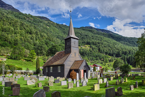 Graveyard and wooden old church in the mountains