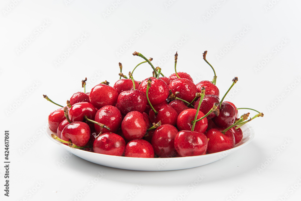 Cherry berries fruit in a plate on white background.Close-up. Cherry berries fruit in a plate on white background.Close-up.