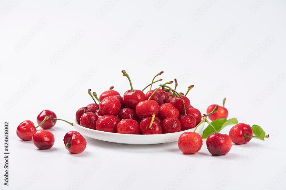 Cherry berries fruit in a plate on  white background.Close-up. 