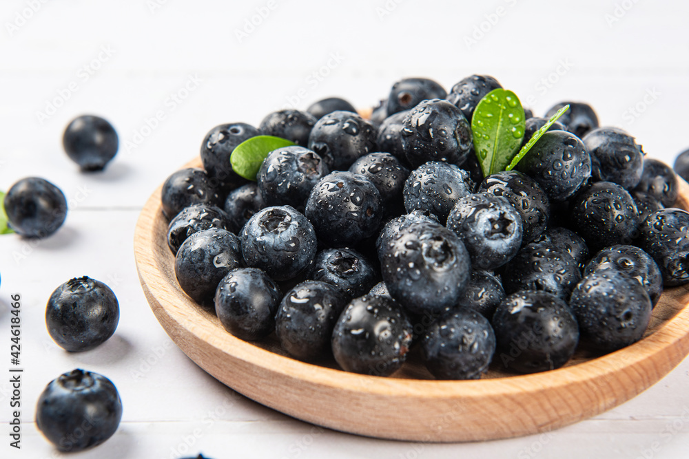 Fresh blueberry with drops of water on wood background Fresh blueberry with drops of water on wood background