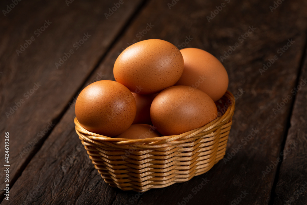 Basket with brown chicken eggs goes up the table. Basket with brown chicken eggs goes up the table.