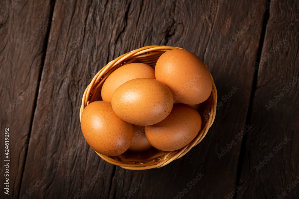 Basket with brown chicken eggs goes up the table. Basket with brown chicken eggs goes up the table.