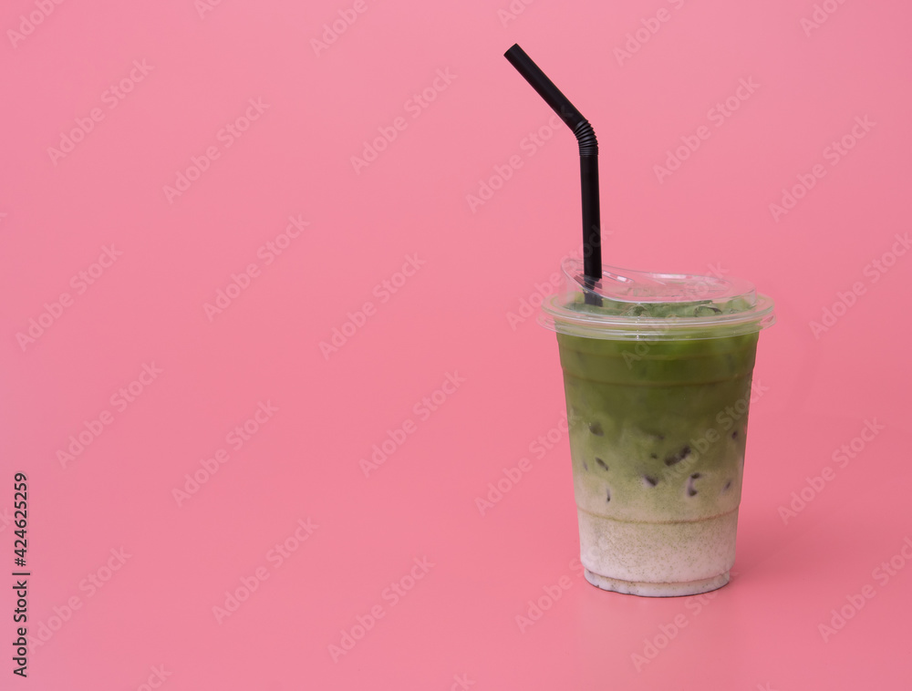 Iced Green Tea with ice on pink background Iced Green Tea with ice on pink background