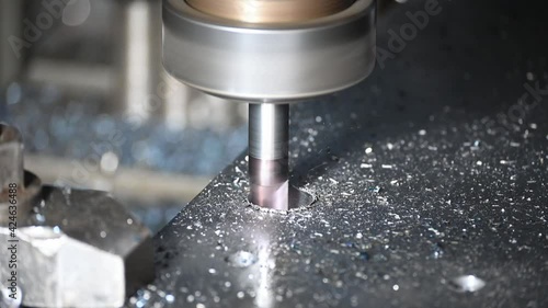 Close-up scene of counterbore cutting process on CNC milling machine with solid end mill tool. The hole processing on machining center. photo