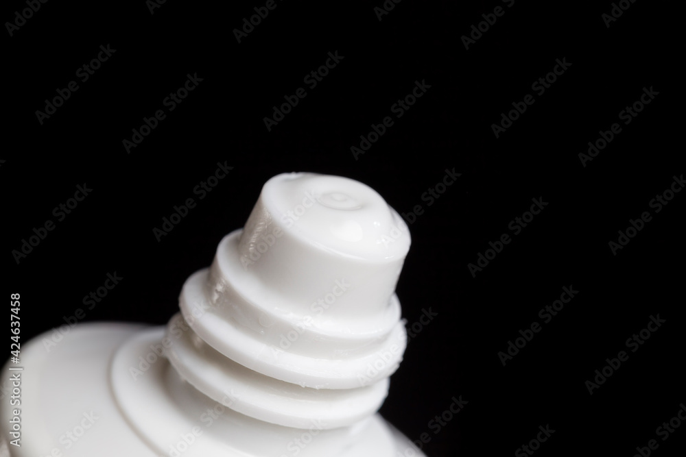 sealed part of a plastic tube of white color and cosmetic sealed part of a plastic tube of white color and cosmetic
