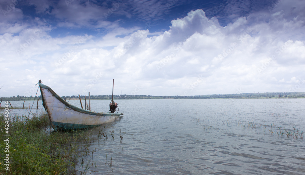 An Awesome panoramic picture of the kabini backwater with a wooden boat and vibrant sky makes for perfect travel destinations  in Karnataka,India.
