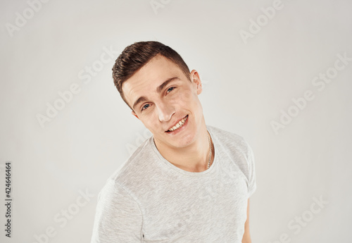 Handsome man trendy haircut white t-shirt close-up Studio
