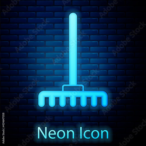 Glowing neon Garden rake icon isolated on brick wall background. Tool for horticulture, agriculture, farming. Ground cultivator. Housekeeping equipment. Vector