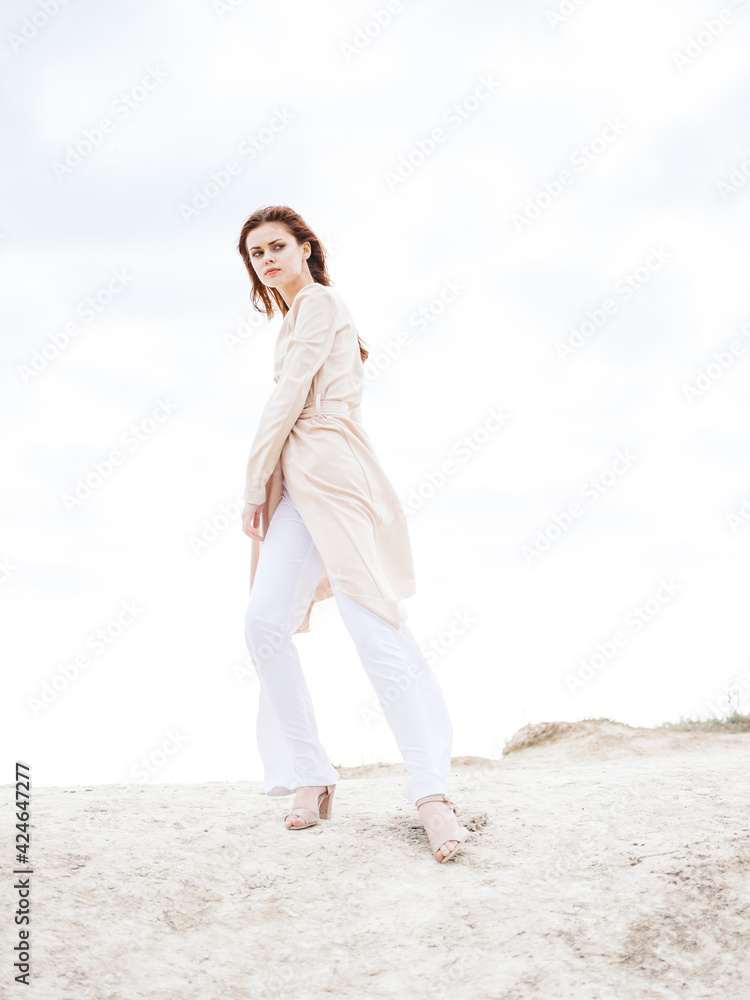 Woman in light clothes outdoors clouds blue sky sand Woman in light clothes outdoors clouds blue sky sand