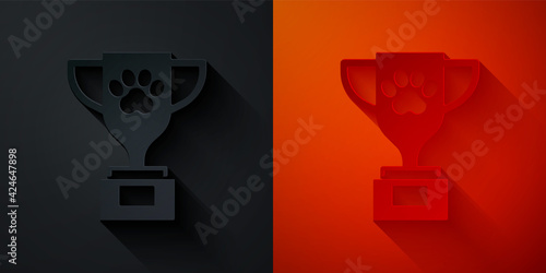 Paper cut Pet award symbol icon isolated on black and red background. Medal with dog footprint as pets exhibition winner concept. Paper art style. Vector