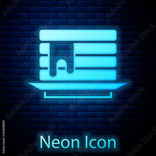 Glowing neon Stack of pancakes with honey icon isolated on brick wall background. Breakfast concept. Vector