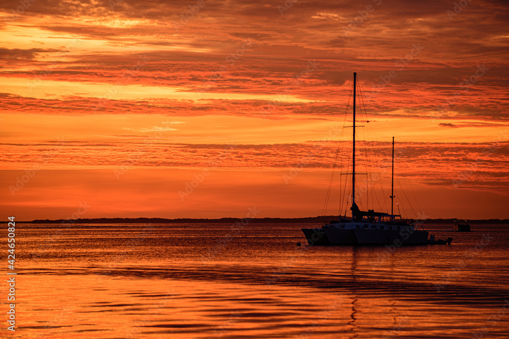 Travel yachting cruise. Sailboats at sunset. Ocean yacht sailing along water.