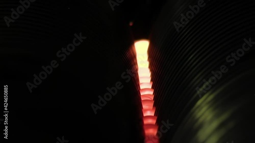 Old Glass Marble Making Machine in a Glass Marble Factory, Large Machine Dropping Molten Glass on Iron Rolls. Close Up. photo