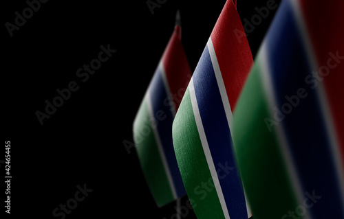 Small national flags of the Gambia on a black background
