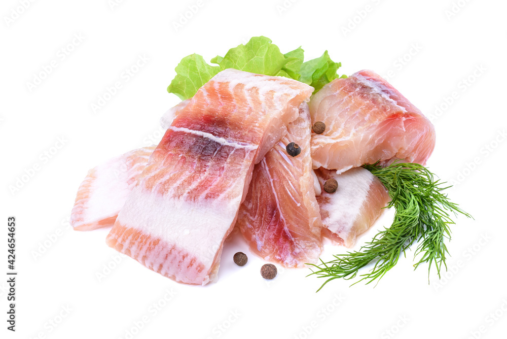 Pangasius fish fillet, pieces on a green lettuce leaf. Isolated on a white background. Fresh Fish Fillet.
