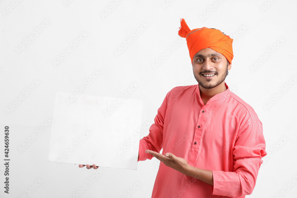 Young indian farmer holding white card board on white background. Young indian farmer holding white card board on white background.