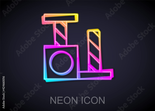 Glowing neon line Cat scratching post with toy icon isolated on black background. Vector