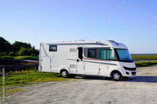 RV holiday trip in motorhome Caravan car Vacation with large Camper van parked aside sea coast beach