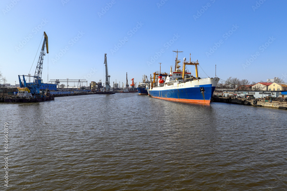 Kaliningrad sea trade port. Ships and cranes in the port. Fishing trawlers