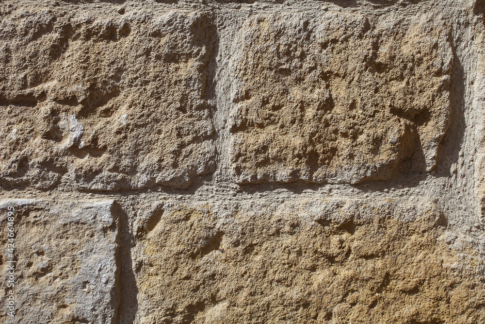 Background masonry, old wall of rectangular stones.