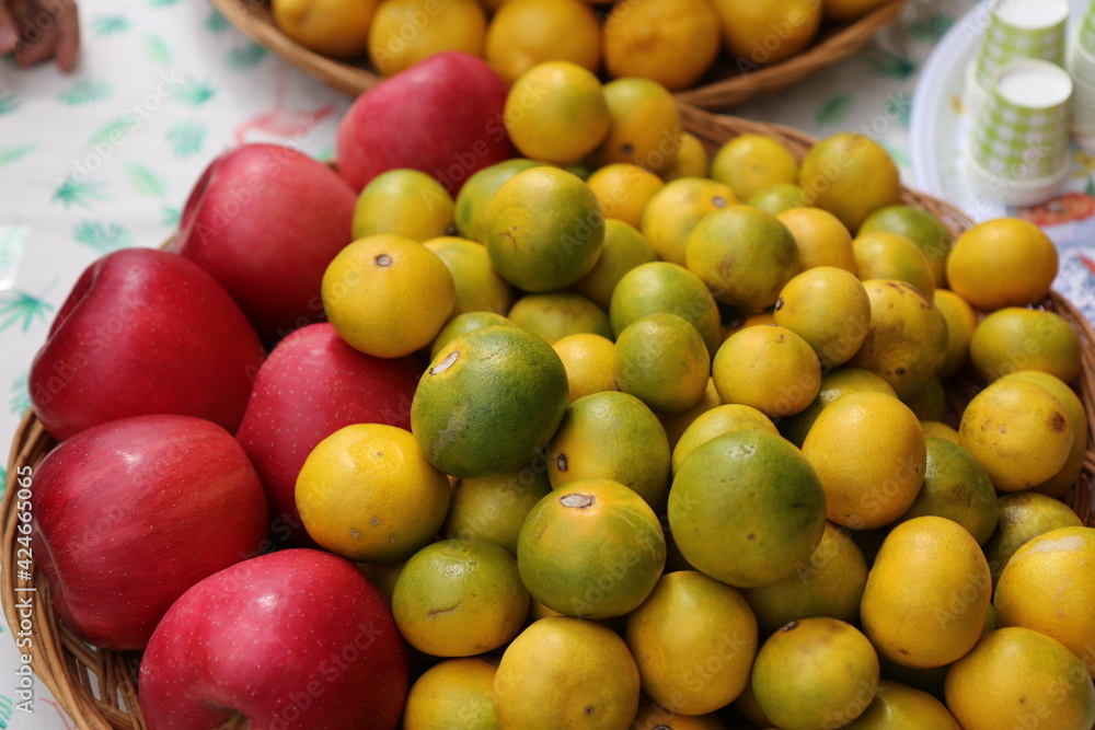 Fruit, tangerines and apples in a basket Fruit, tangerines and apples in a basket