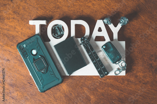 Wallpaper Mural Top down photo of every day carry items, edc, phone, card holder, knife, car keys, rings, bracelet. Torontodigital.ca