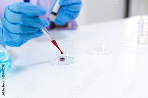 Scientist holding Coronavirus covid-19 infected blood sample tube DNA testing of the blood in the laboratory with blood sample collection tubes and syringe Coronavirus Covid-19 vaccine research.