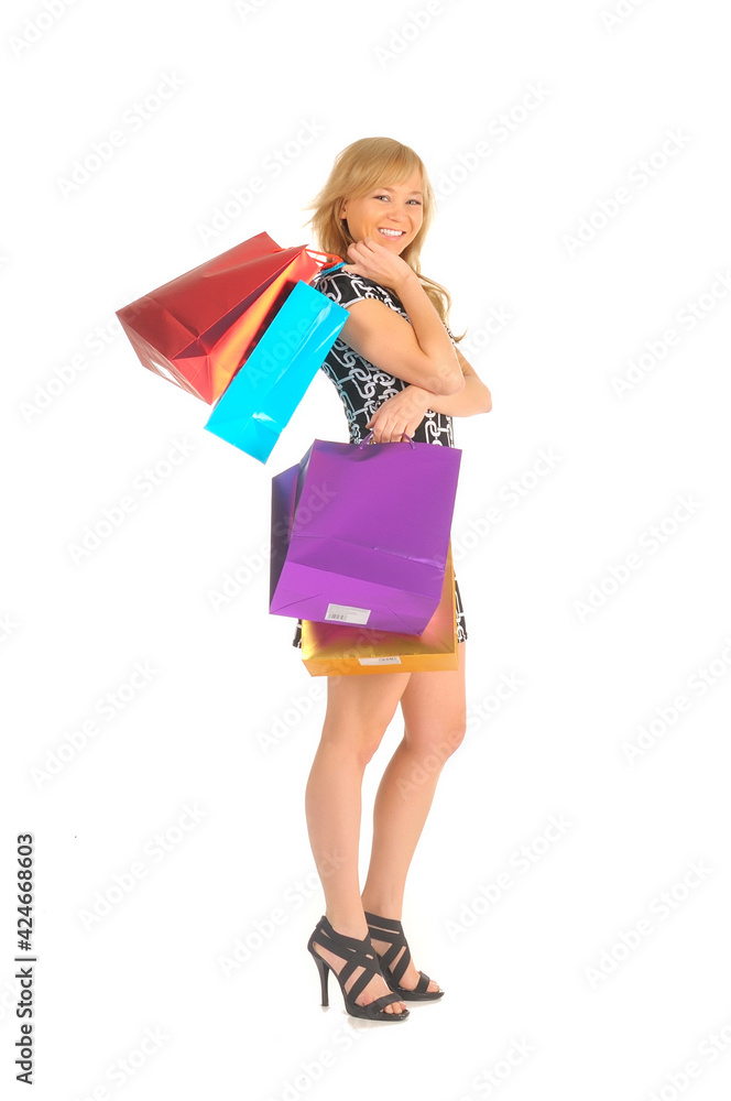 Beautiful woman with a lot of shopping bags. isolated on white