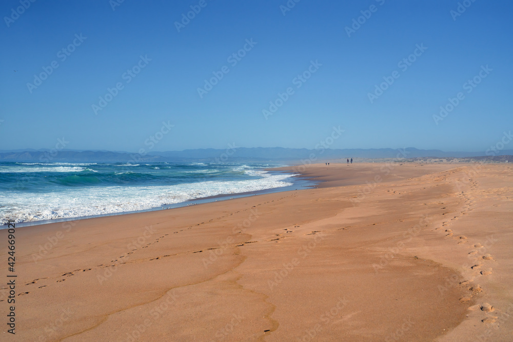 Wide sandy beach and ocean view. Beautiful seascape, clear blue sky background, copy space Wide sandy beach and ocean view. Beautiful seascape, clear blue sky background, copy space