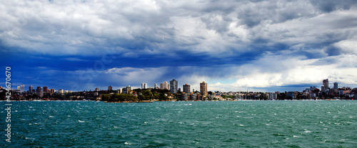 Fotografija Wide angle view from sea looking into Sydney where cloud and heavy rain settling over city