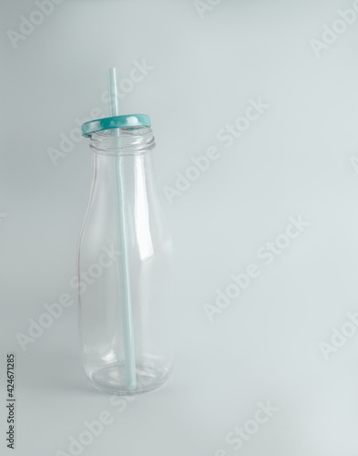 Empty bottle with eco friendly glass drinking straw. Zero Waste concept.