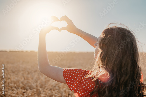 Vitamin D in Womens Health, Role of Vitamin D3 Supplements in female health. Young woman enjoying sun in nature background photo