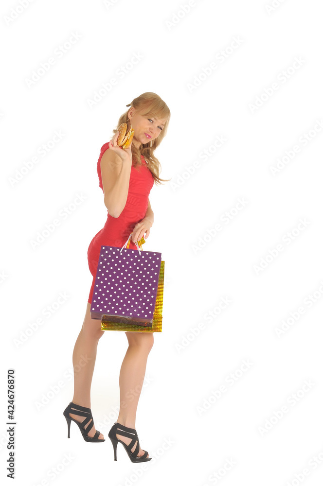 Young beautiful woman with some shopping bags and hamburger isolated on white Young beautiful woman with some shopping bags and hamburger isolated on white