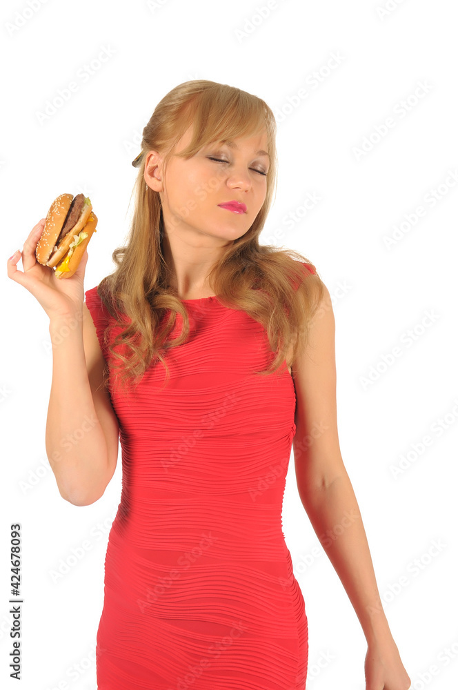 Young beautiful woman with some shopping bags and hamburger isolated on white Young beautiful woman with some shopping bags and hamburger isolated on white