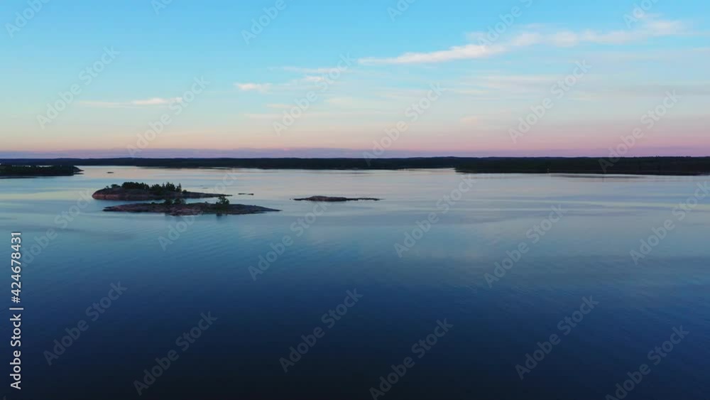Aerial view of small islands, on the Baltic sea summer dusk - rising drone shot Aerial view of small islands, on the Baltic sea summer dusk - rising drone shot