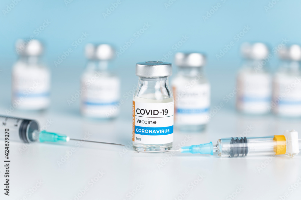 Coronavirus Covid-19 Vaccine vial glass bottles and syringe. Coronavirus Covid-19 Vaccine vial glass bottles and syringe.