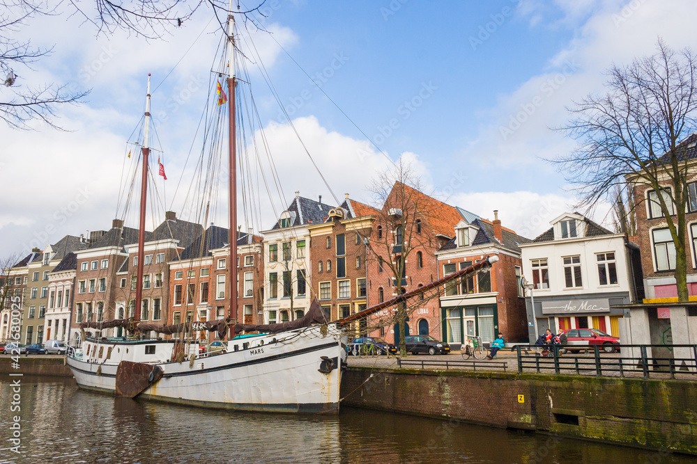 Houses along Hoge der A in Groningen, with old ships in front of the former warehouses, in The Netherlands.