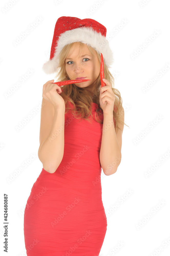 Attractive young woman in Santa Cap with chili pepper. isolated on white Attractive young woman in Santa Cap with chili pepper. isolated on white