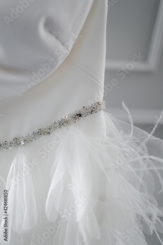white ostrich feathers on the wedding dress