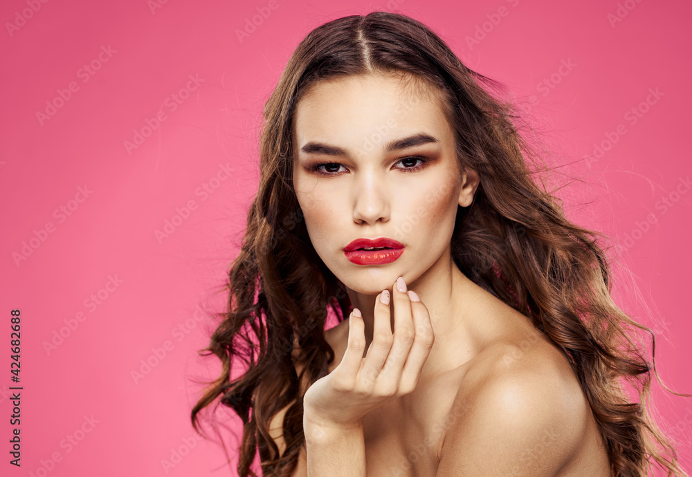 Sexy brunette model pink background red lips bared shoulders Sexy brunette model pink background red lips bared shoulders