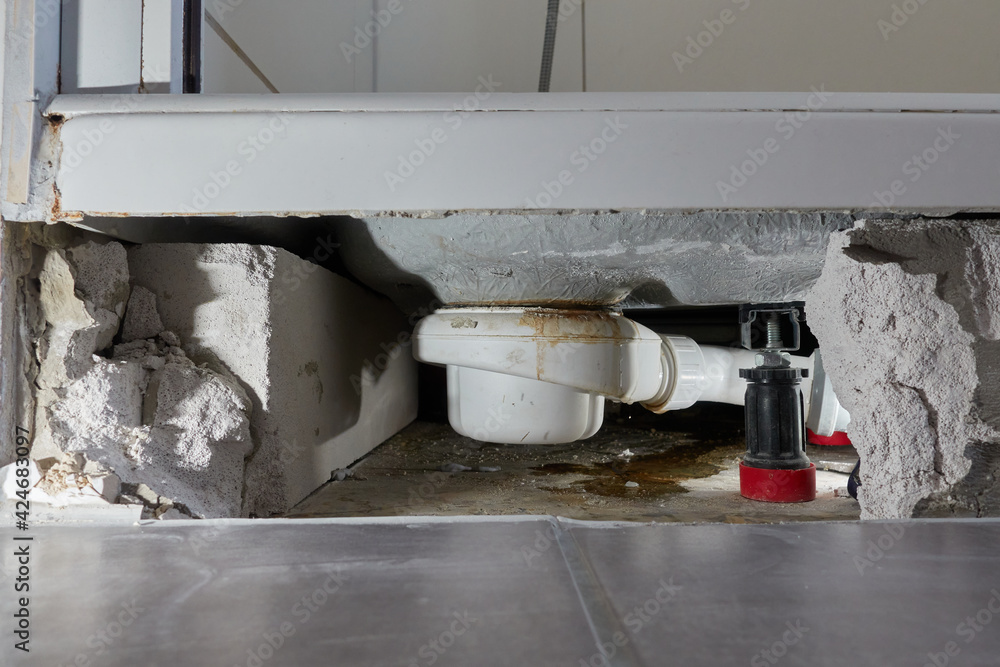 Leaking siphon of a shower tray in the bathroom, causes water damage