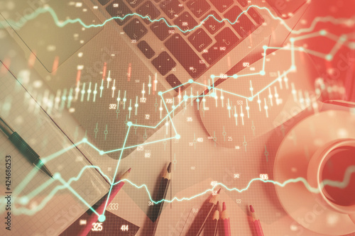 Double exposure of financial chart drawing over table background with computer. Concept of research and analysis. Top view.