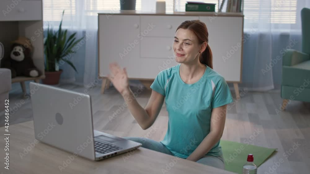 yoga online, adult girl in sportswear doing physical exercises with a coach via video link while sitting at home yoga online, adult girl in sportswear doing physical exercises with a coach via video link while sitting at home
