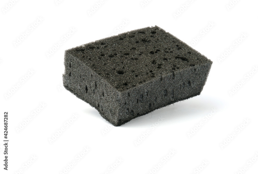 black kitchen sponge isolated on white . the concept of cleanliness and order black kitchen sponge isolated on white . the concept of cleanliness and order