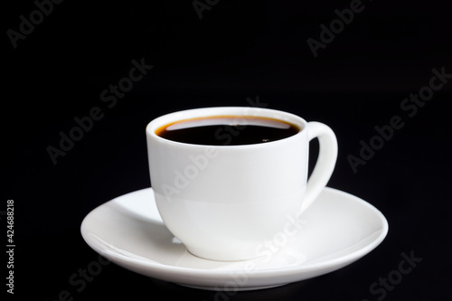 white glass cup with black delicious aromatic coffee
