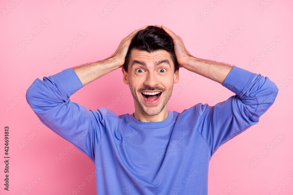 Portrait of impressed cheerful person arms on head open mouth isolated on pastel pink color background Portrait of impressed cheerful person arms on head open mouth isolated on pastel pink color background