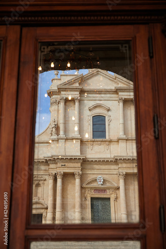 The Cathedral of San Nicolò in Noto is the cathedral of the Diocese of Noto of the ecclesiastical region of Sicily, founded in 1844. Part of the church to be seen in a window reflection. 