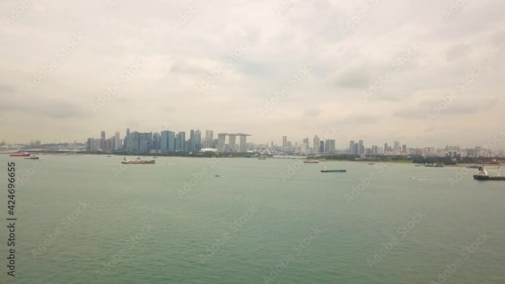 Sped up drone shot of Singapore anchorage and city skyline Sped up drone shot of Singapore anchorage and city skyline